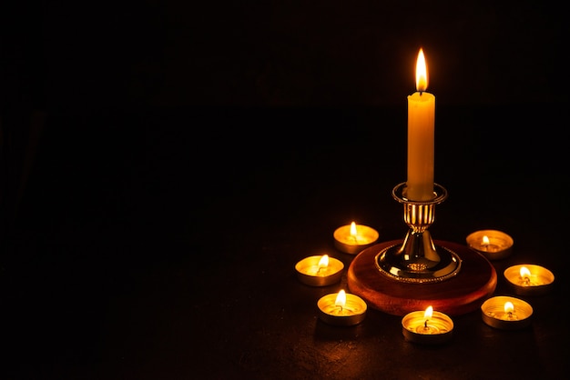 Free photo front view of burning candles as memory for fallen dark surface