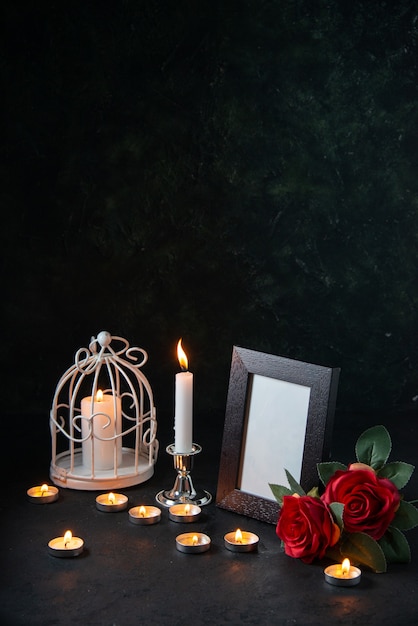 Free photo front view burning candles with picture frame as memory for fallen dark surface