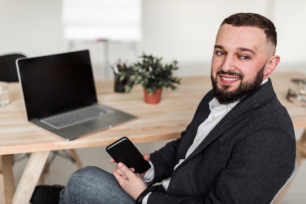 Free photo front view of business man at desk