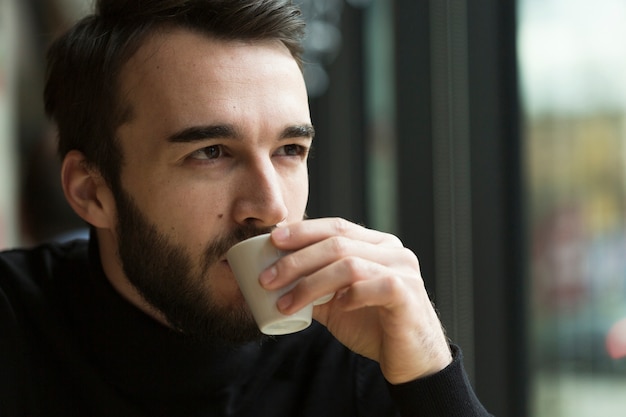 Front view business man drinking coffee