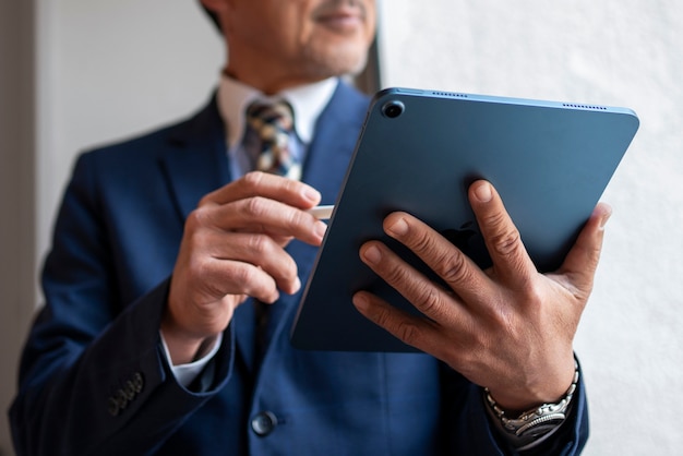 Front view business man holding tablet