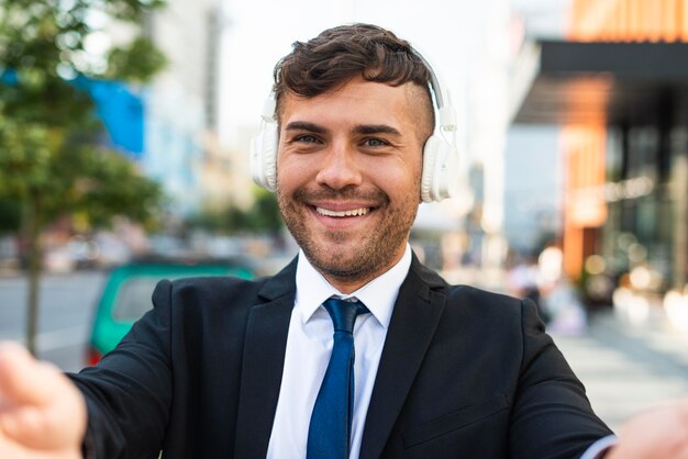 Front view business man listening to music