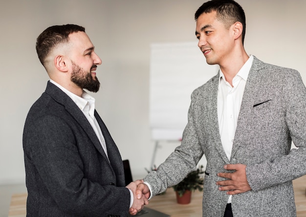 Free photo front view of business men talking