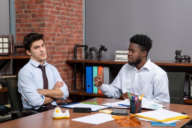 Front view business negotiations serious young businessmen discussing something