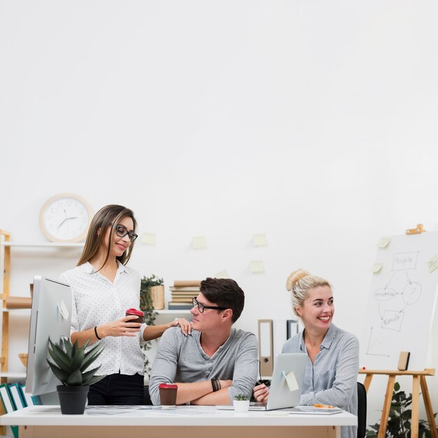 Front view business partners sitting at a desk