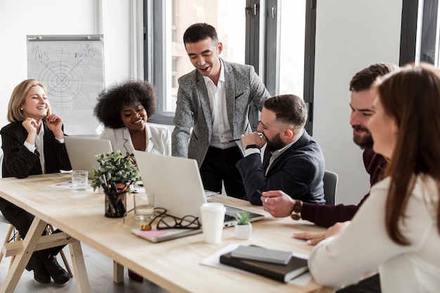 Free photo front view of business people in meeting