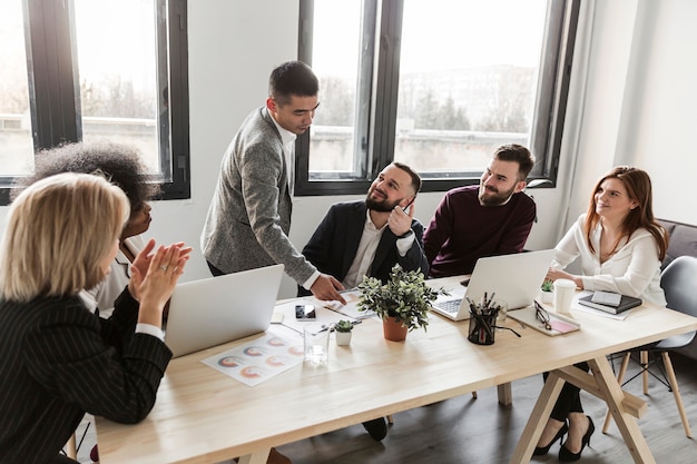 Free photo front view of business people in meeting