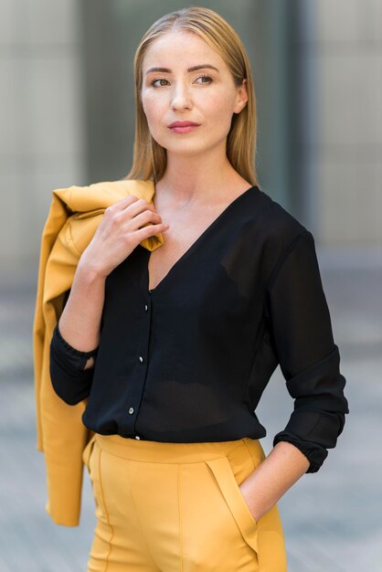 Front view of business woman posing outdoors in suit