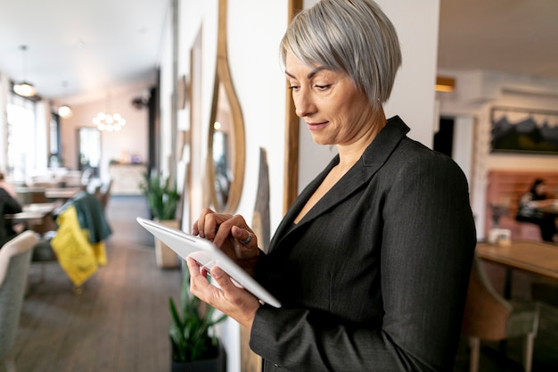 Front view business woman reading from tablet