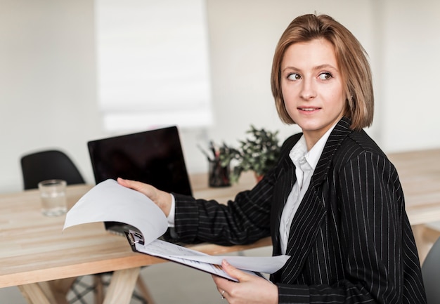 Front view of business woman with clipboard