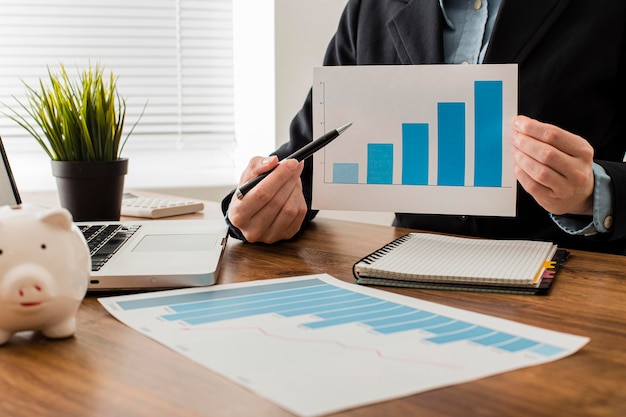 Front view of businessman holding growth chart