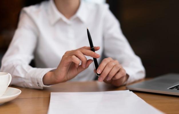 Front view businessman holding a pen