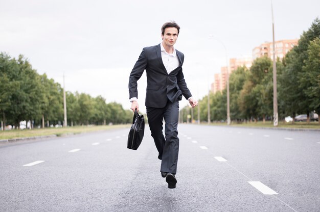 Front view of businessman running