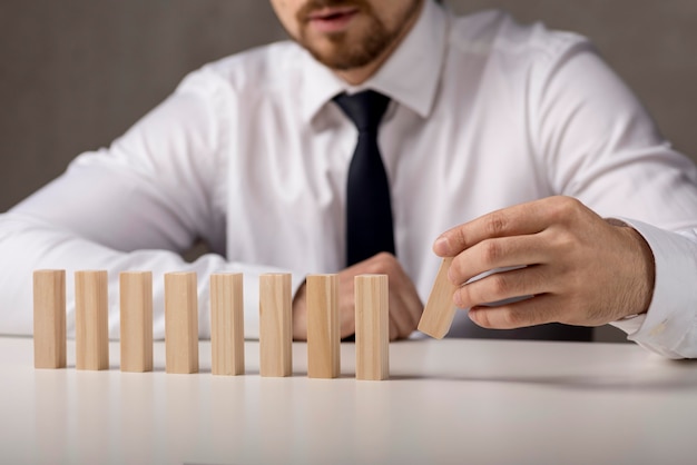 Front view of businessman with dominoes