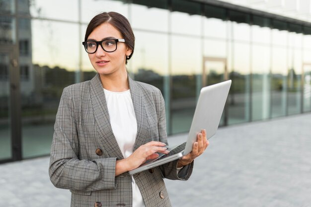 Front view of businesswoman holding smartphone