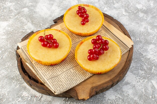 Front view of cake with cranberries yummy and perfectly baked on the wooden desk