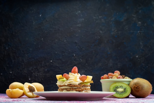 Front view of cake with cream and fruits on the dark surface