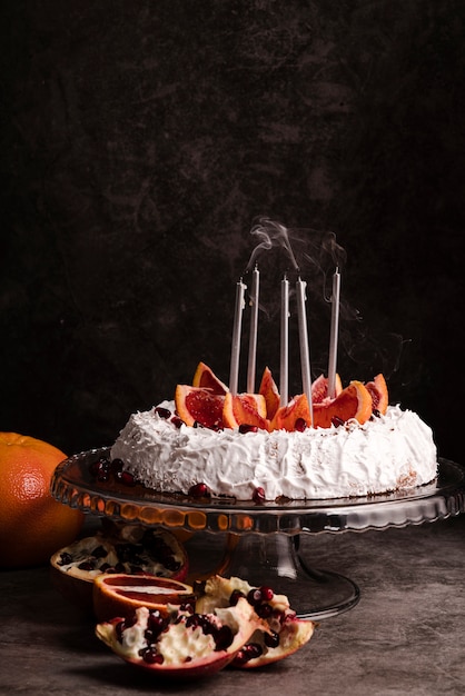 Front view of cake with fruit and candles