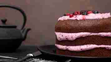 Free photo front view of cake with knife and tea pot