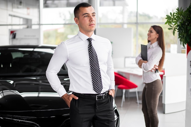 Free photo front view car dealers coworkers at office