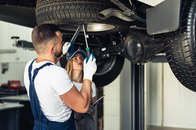 Front view car service mechanics repairing car