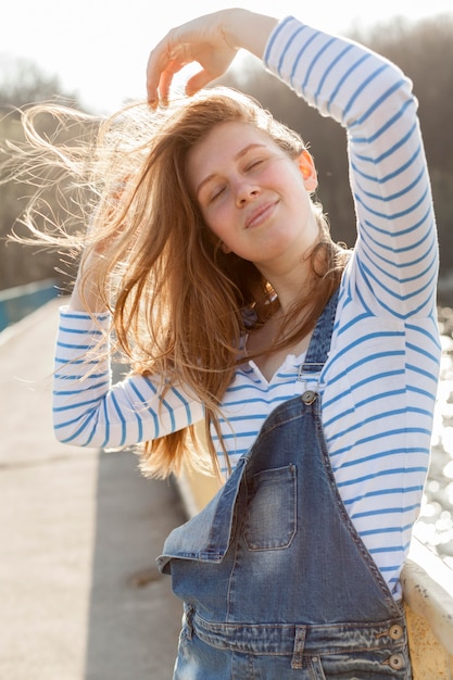 Front view of carefree woman posing in the wind