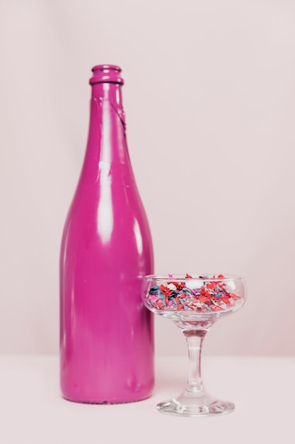 Front view of champagne glass and bottle