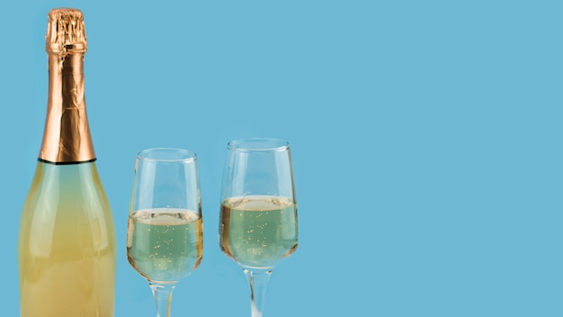 Front view of  champagne and glasses with copy space