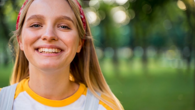 Front view of cheerful woman posing outdoors