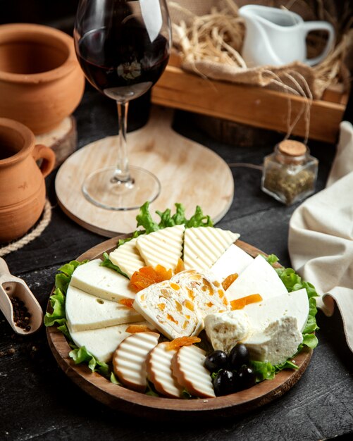 Front view cheese plate with a glass of red wine