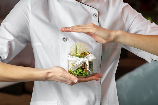Front view of  chef holding delicious food