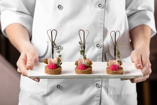 Front view of chef holding a food plate