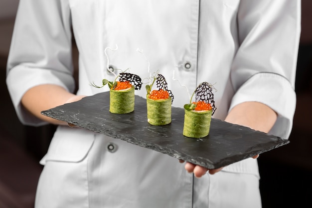 Front view of chef holding a food plate
