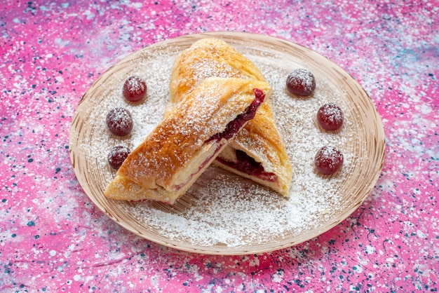 Front view of cherry pastry delicious and sweet sliced with fresh sour cherries and sugar powder
