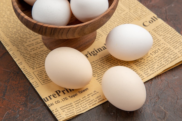 Front view chicken eggs inside plate on dark surface