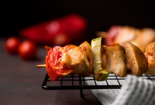 Front view chicken skewer on tray with red pepper