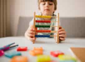 Free photo front view of child using abacus at home