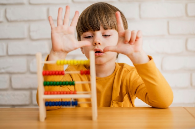Front view of child using abacus to learn how to count