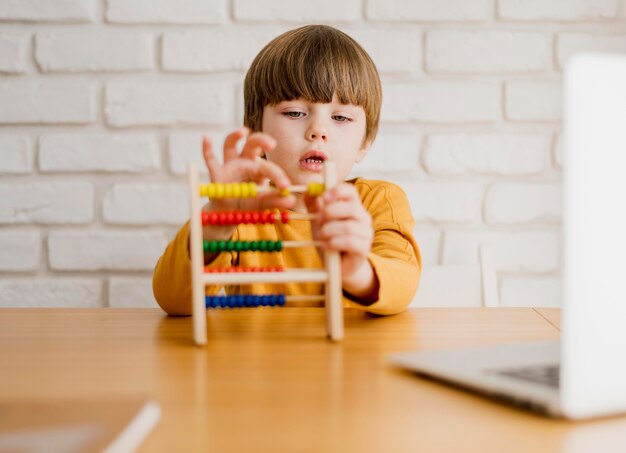 Front view of child with abacus at desk