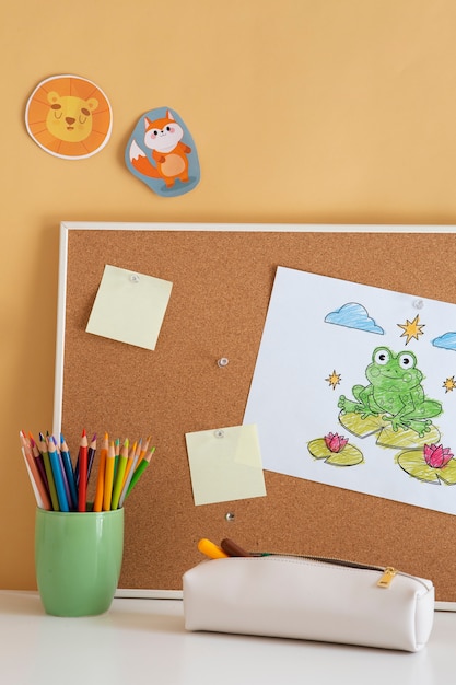 Free photo front view of children's desk with board and sticky notes