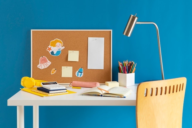 Front view of children's desk with lamp and notebook