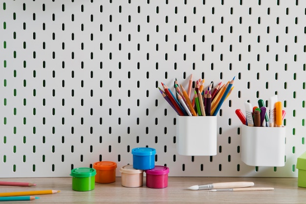 Free photo front view of children's desk with organizer and pencils