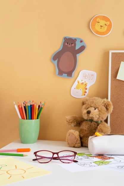 Front view of children's desk with teddy bear and glasses