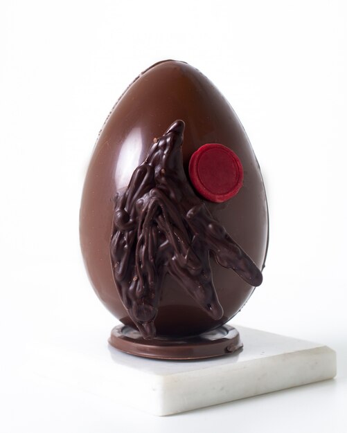 Front view choco egg on the white desk