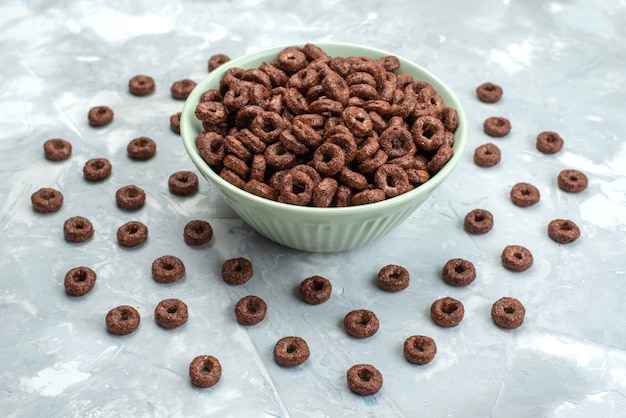 Front view chocolate cereals inside green plate on the blue background cacao breakfast food cereals health