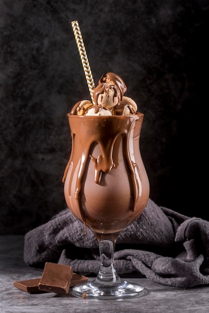 Front view of chocolate dessert in glass with straw