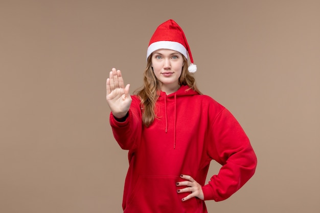 Front view christmas girl asking to stop on brown background model holiday christmas