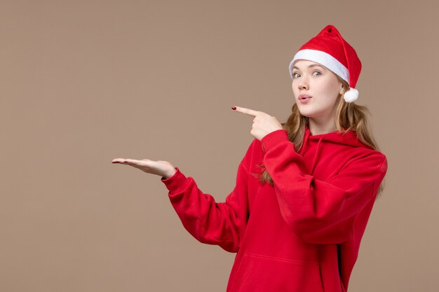 Front view christmas girl posing on brown background new year christmas holiday