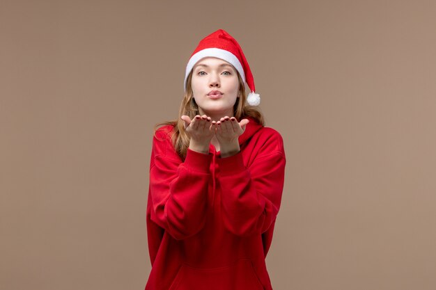 Front view christmas girl sending air kisses on brown background woman holiday christmas