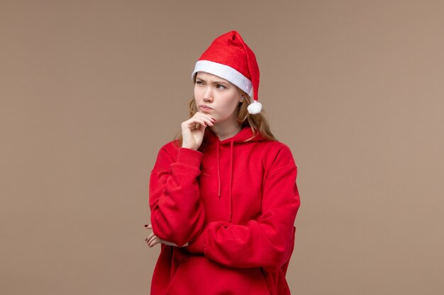 Front view christmas girl thinking on the brown background model holiday christmas